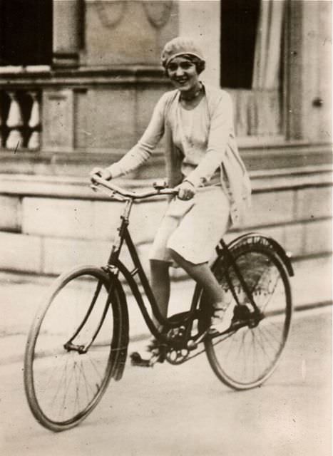 Mary Pickford riding a bike.