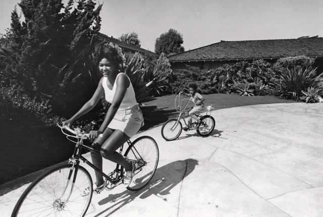 Mary Wilson and Pedro Antonio Jr. ride bikes.