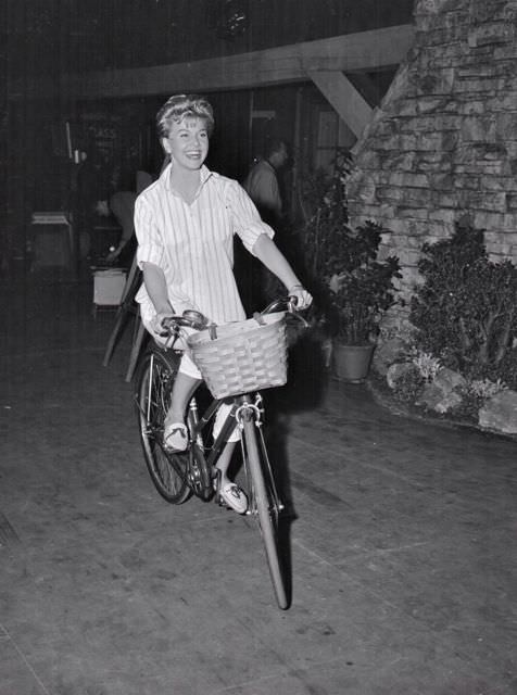 Doris Day riding a bike.