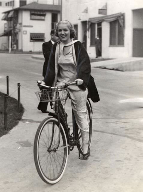 Mary Pickford riding a bike.