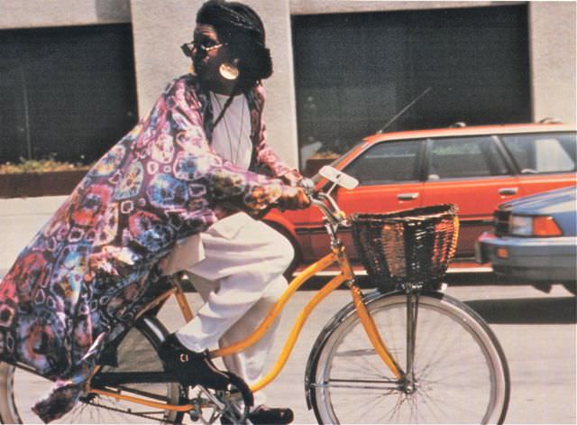 Whoopi Goldberg riding a bike.