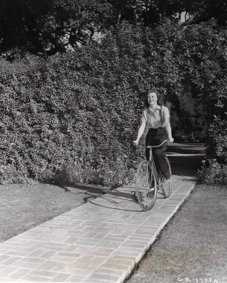 Ginger Rogers riding a bike.