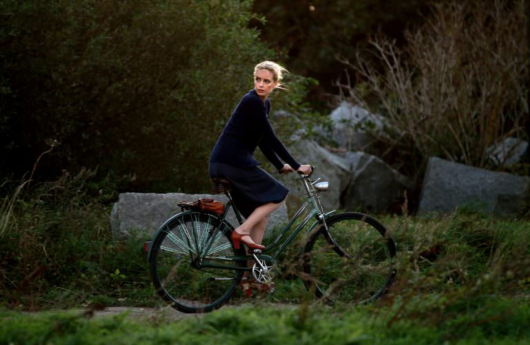 Nina Hoss riding a bike.