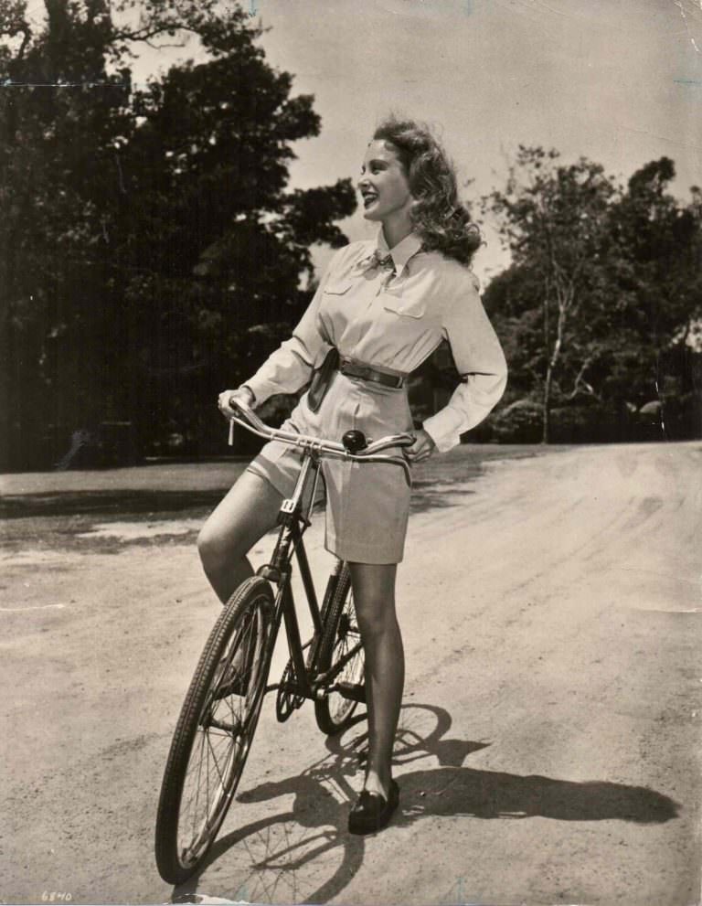 Janet Leigh posing on a bike.