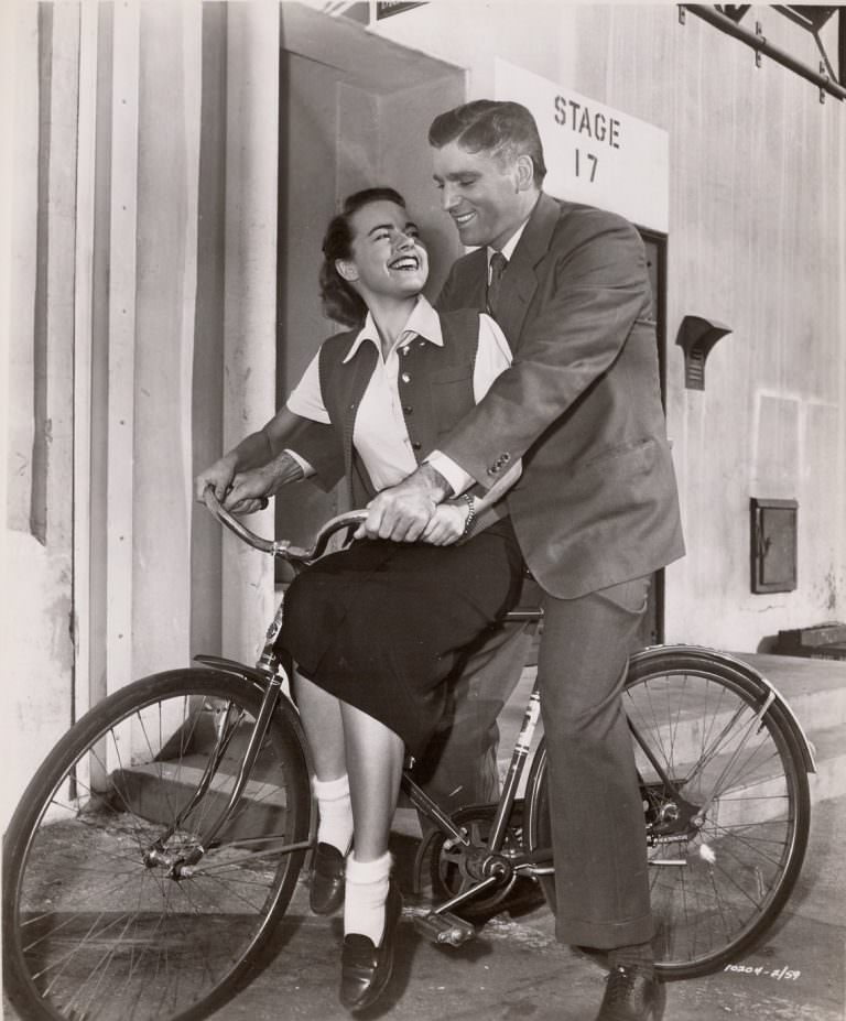 Terry Moore and Burt Lancaster on a bike, 1953
