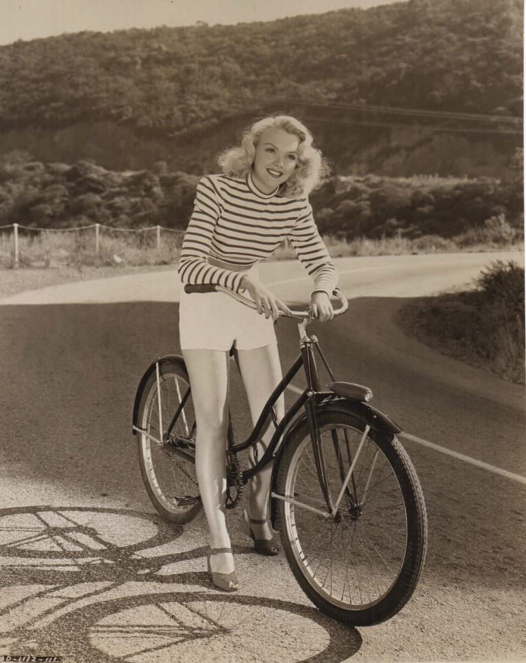 Mickey Rooney, Cecilia Parker, Fay Holden and Lewis Stone on a bike.