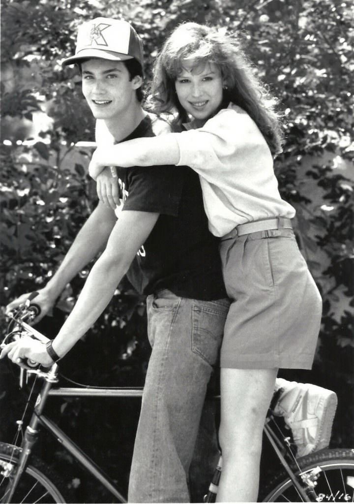 Randall Batinkoff and Molly Ringwald on a bike.