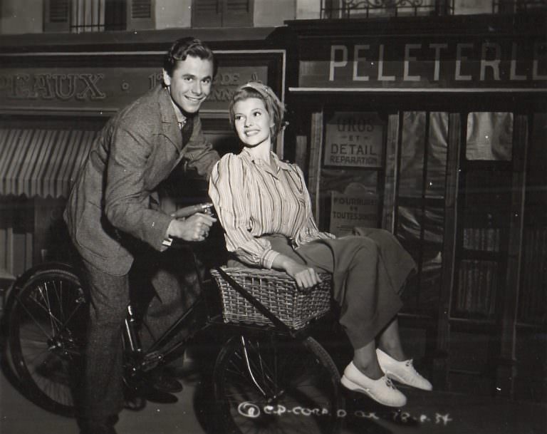 Glenn Ford and Rita Hayworth on a bike.