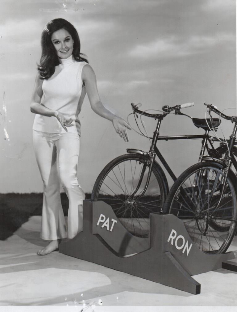 Valerie Perrine and David Ackroyd holding a bike.