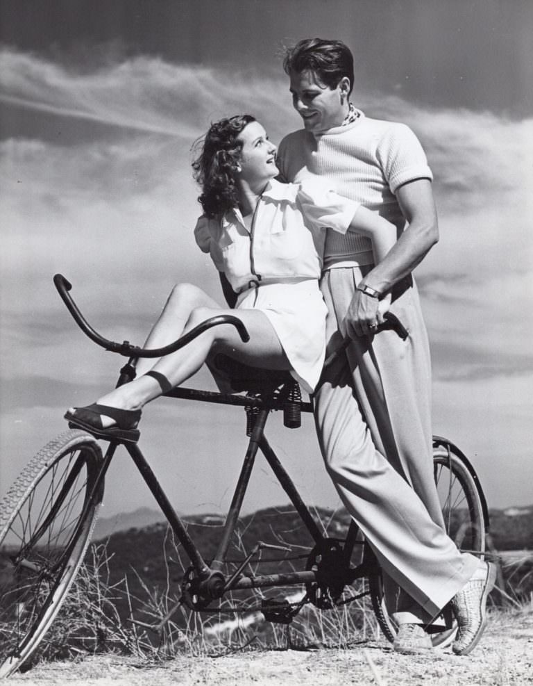 James and Gertrude Ellison rest on a bike, 1938