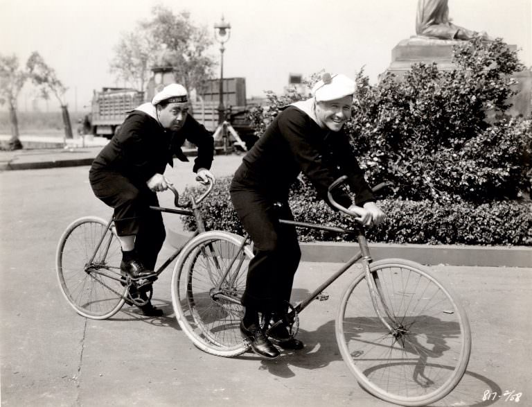 Eugene Pallette and Jack Oakie on bikes, 1930