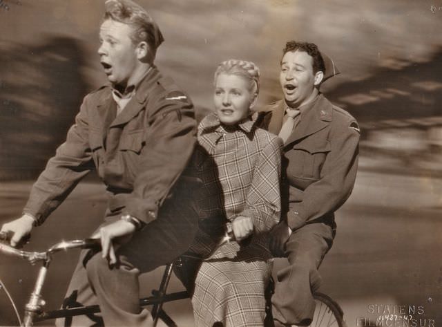 Bill Murphy, Jean Arthur and Stanley Prager riding a bike.