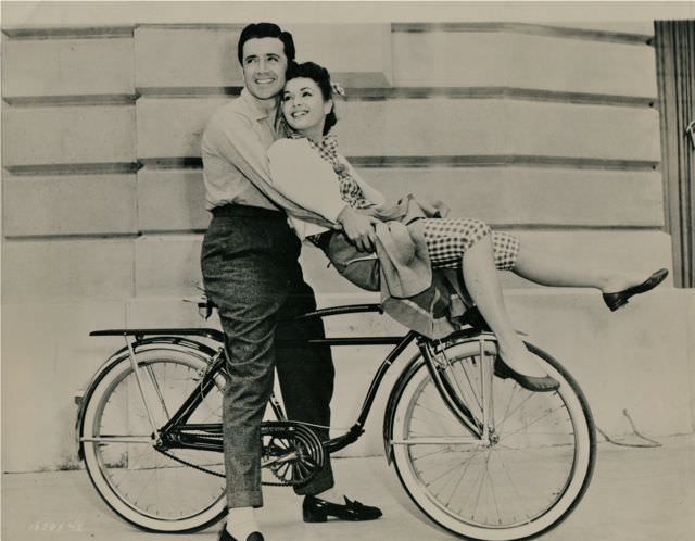 Vic Damone and Debbie Reynolds on a bike