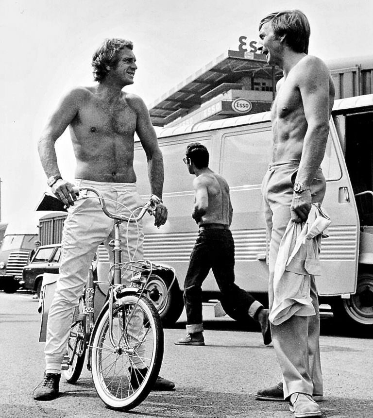 Steve McQueen on a bike, shirtlessly.