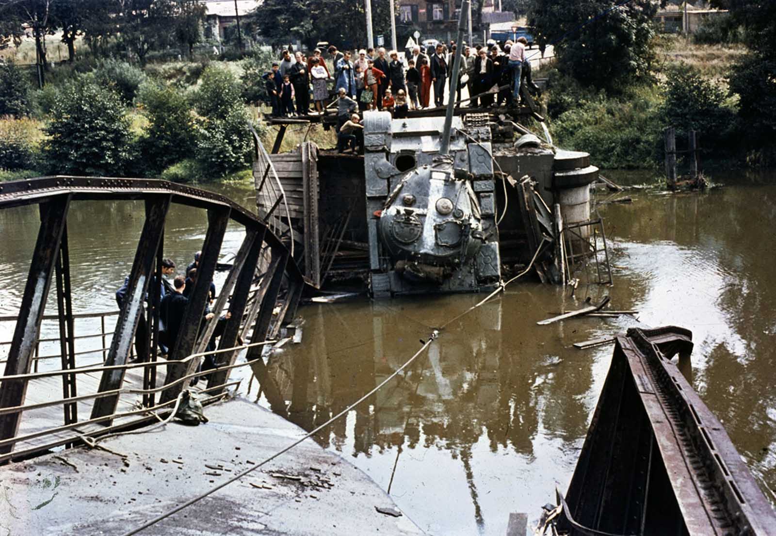 A Soviet tank is out of action after a bridge it was crossing gave way on August 21, 1968.