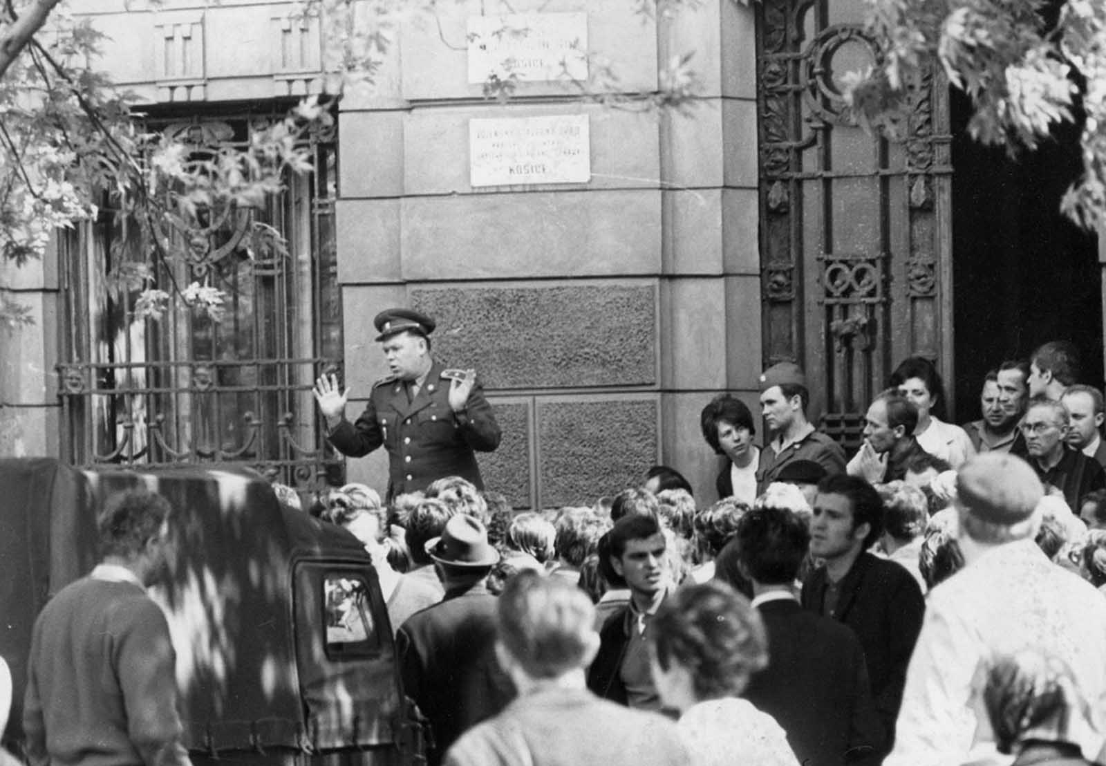 A member of the Czechoslovakian army is jeered by locals in Košice, Czechoslovakia.