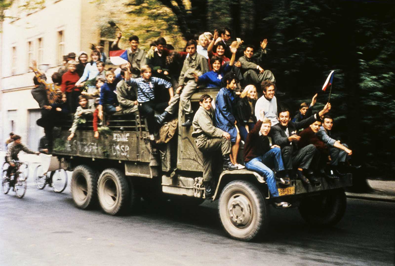 Czechoslovakian army trucks take young people around Prague as Soviet tanks had halted on the outskirts of town and began a siege of Czech army barracks.