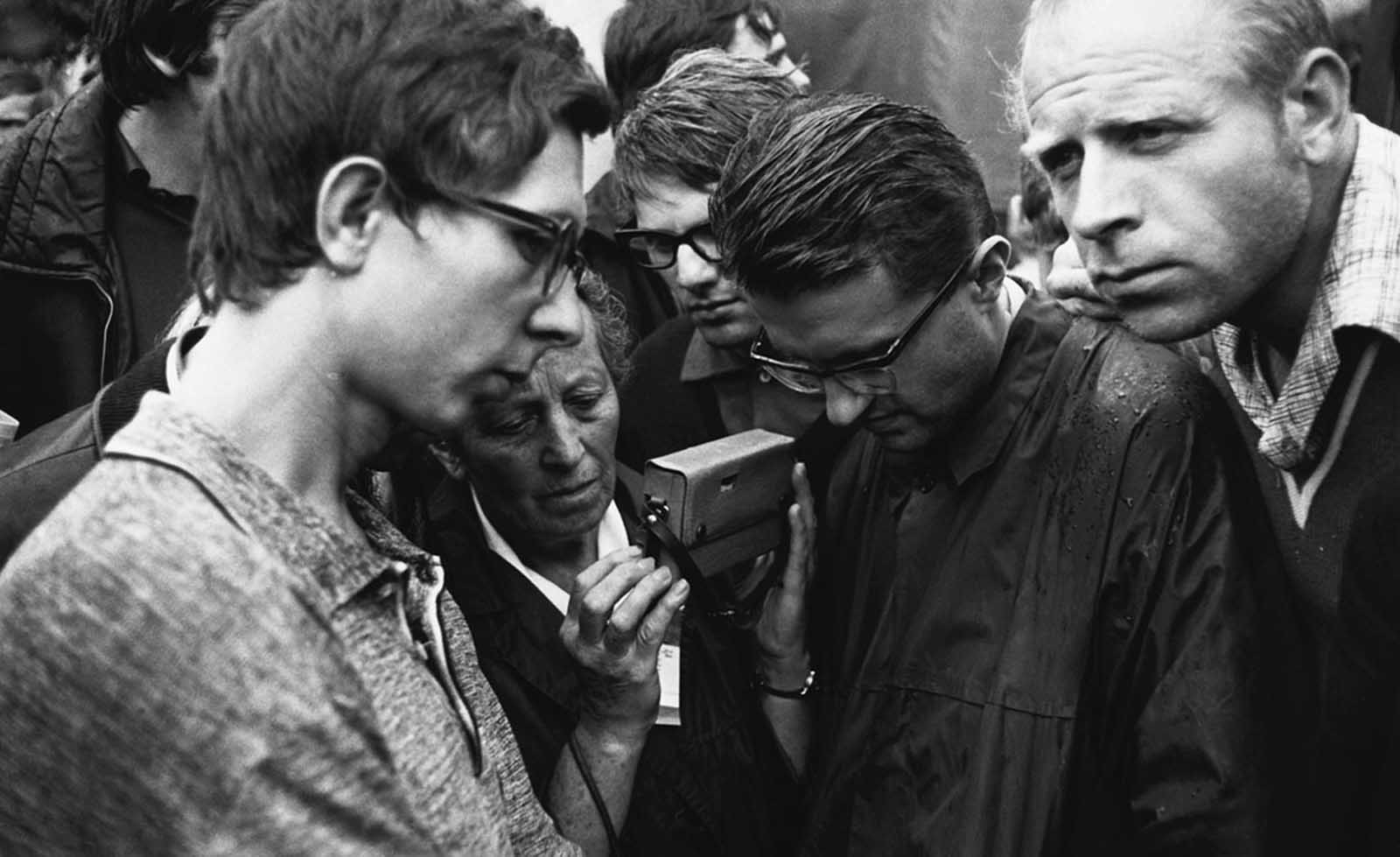 Czechoslovakians gather to listen to a transistor radio for news of the Soviet invasion and occupation on August 29, 1968.