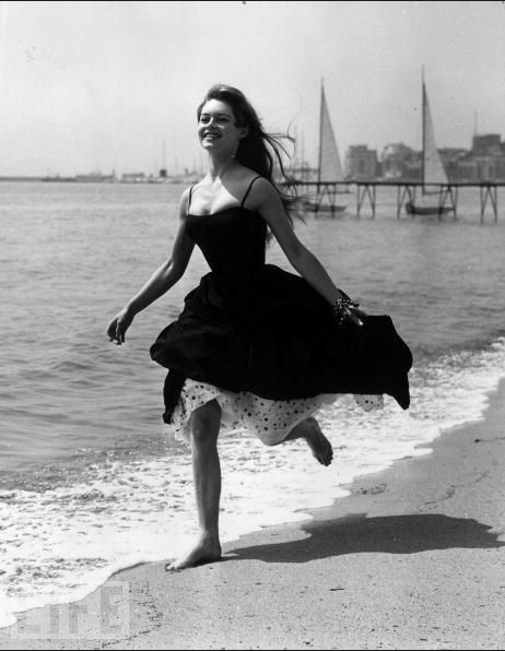 Brigitte Bardot runs barefoot on the sands at Cannes in 1956. That year she appeared in the film that launched her to international stardom, "And God Created Woman."