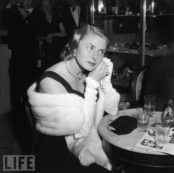 Ingrid Bergman adjusts an earring as she sits at a cocktail table at the Cannes Film Festival in 1956. Jacques Cousteau's "The Silent World" won the Palm d'Or that year, the only documentary to do so until 2004, when Michael Moore won for "Fahrenheit 9/11."