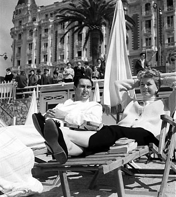 Cannes, France --- Doris Day and her husband Marty Melcher relax in the sun on the beach at Cannes, while in town to attend the 1955 film festival.
