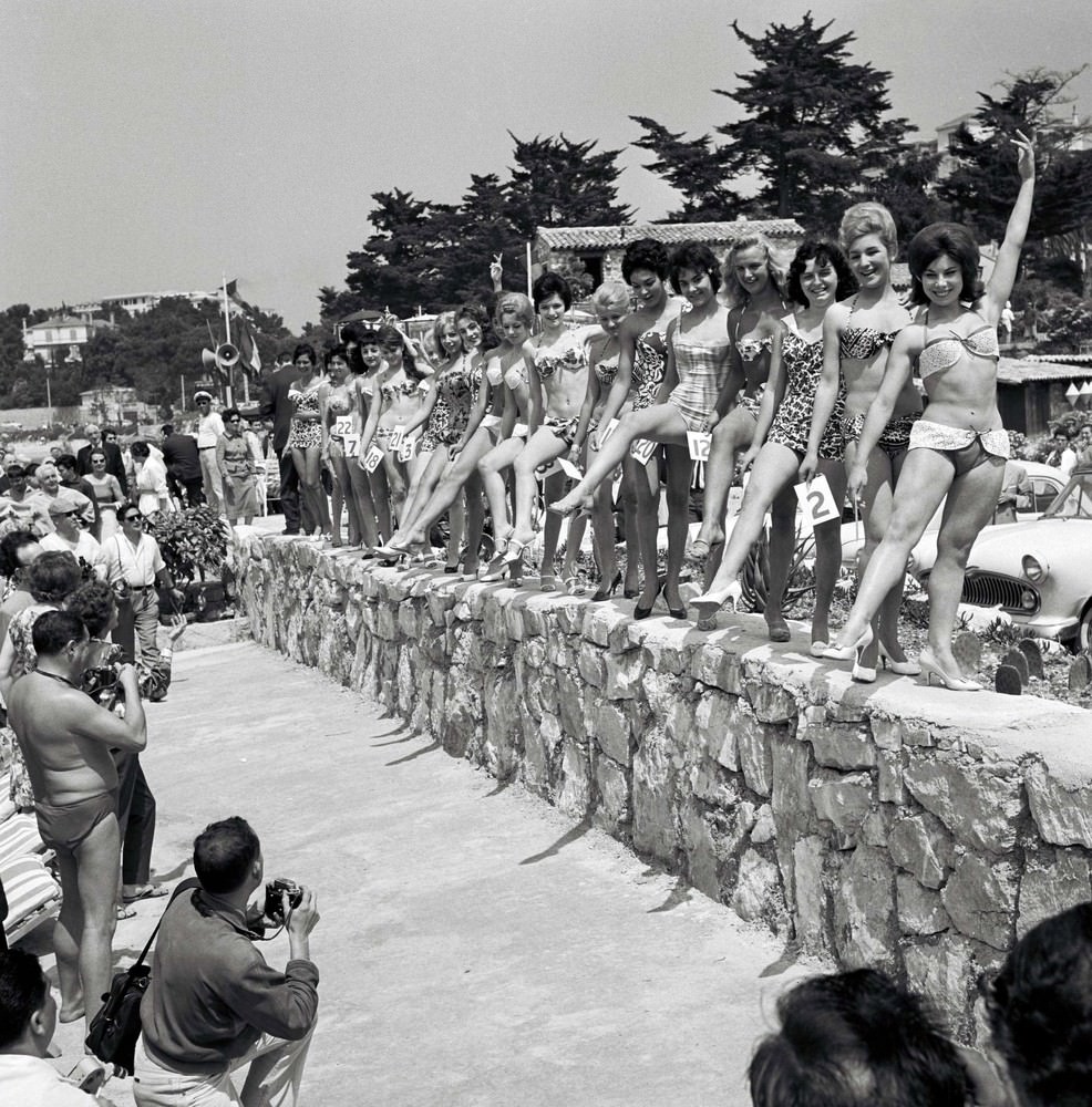 Women dressed in swimming costumes show off their bodies during a beauty contest. The 13th Cannes International Film Festival, France, 1960.