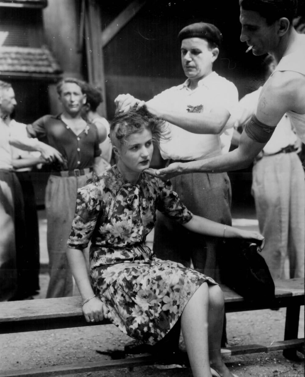 French female collaborator punished by having her head shaved to publicly mark her, 1944.