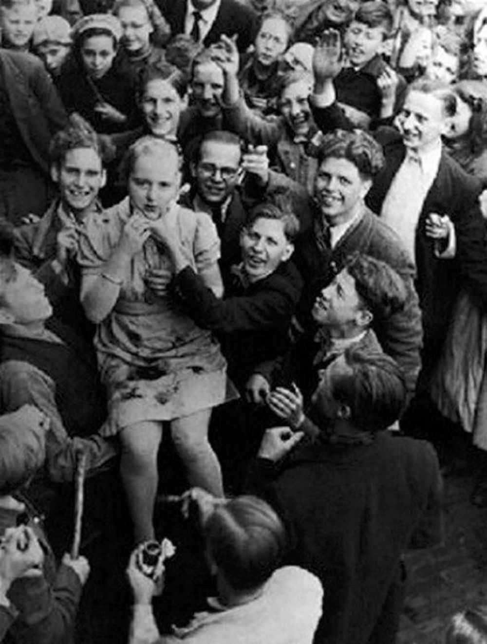 A teenager is brutalized by a mob incited by communist 'partisans'. Note she is being 'painted' by a French 'artist' at the bottom of the screen.