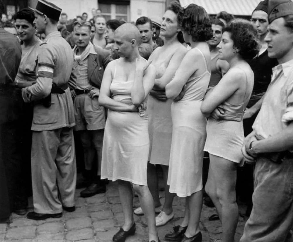 A group of Frenchwomen, who had been accused of collaborating with the Germans, stripped down to their underwear, some with heads shaved, as part of their public humiliation.