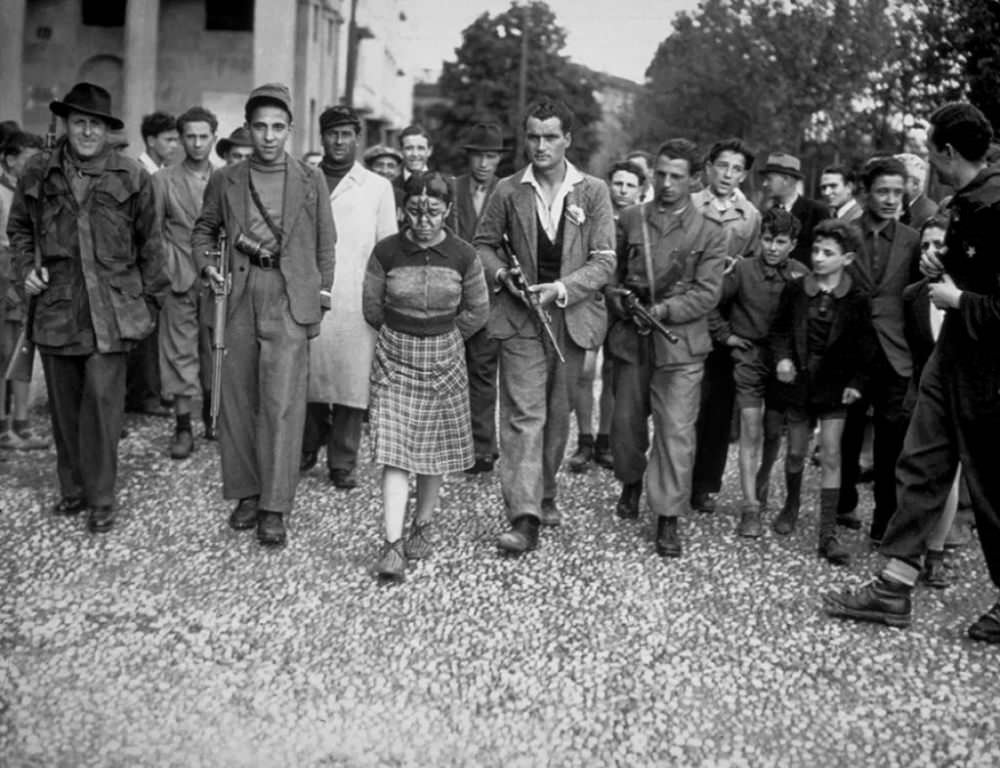 A woman who collaborated with the Nazis has her hair cut as a sign of public disgust.