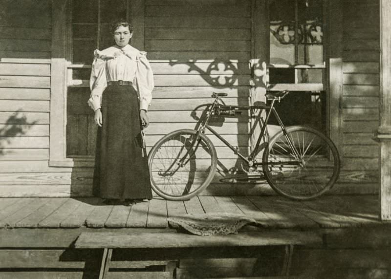 Lady on porch with bike, Greenville, Texas