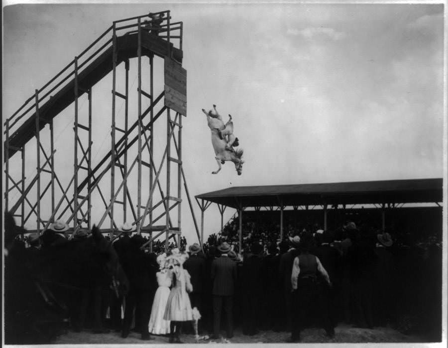 A large crowd of spectators watch Eunice Padfield and her horse dive from a high tower in Pueblo, Colorado on July 4, 1905.
