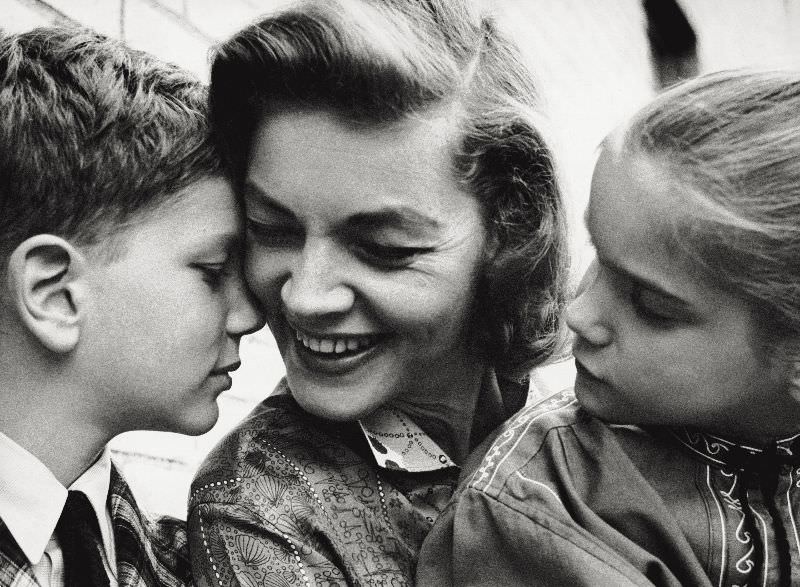 Lauren Bacall tenderly smiling to her children Leslie and Stephen Bogart, New York, 1960.