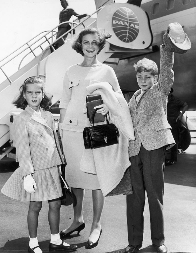 Lauren Bacall smiling with her children Leslie and Stephen Bogart while standing in front of a PanAm airplane at New York International Airport, New York City, 1961.
