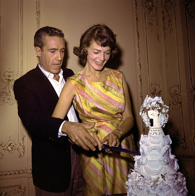 Jason Robards Jr. and Lauren Bacall shown cutting the cake after wedding, 1961.