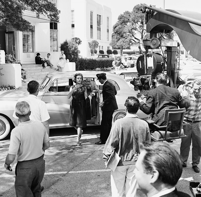 Lauren Bacall on set with crew, 1960s.