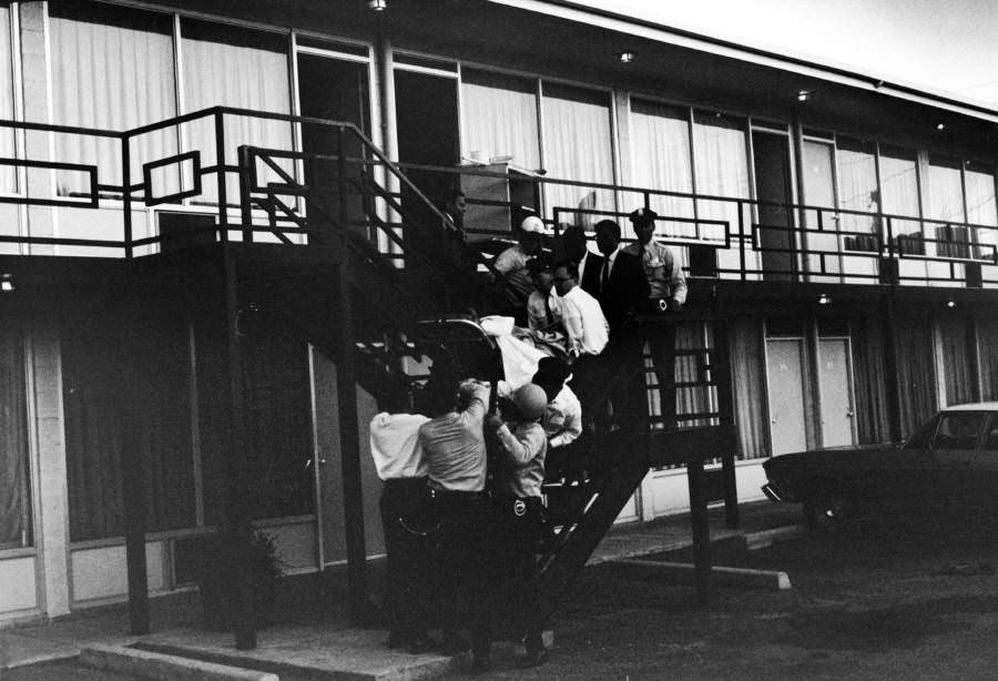 Police and ambulance workers carry the body of Martin Luther King, Jr. down the stairs of the Lorraine Motel. Riots in over 100 American cities would break out shortly after.