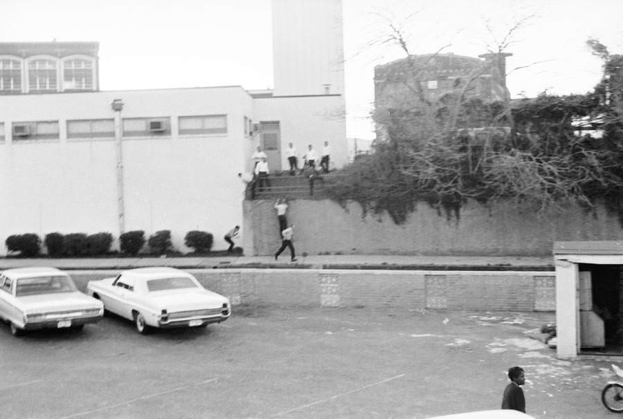 Bystanders run to search for the then-unknown assassin who shot Martin Luther King Jr. from a building just across the Lorraine Motel.