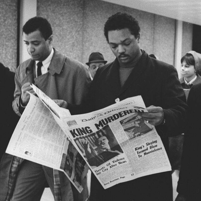 Jesse Jackson saw King give "the most brilliant speech of his life" the night before he was gunned down. He's seen here at O'Hare Airport in Chicago, reading the Daily Defender newspaper in hopes to learn more. April 5, 1968. Chicago, Illinois.