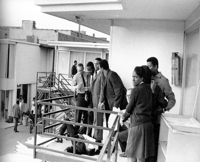The first police officer made it on to the balcony. The man standing to the right of the police officer is King's best friend Ralph Abernathy. You can see the pain on that man’s face as he's looking down at his friend dying.