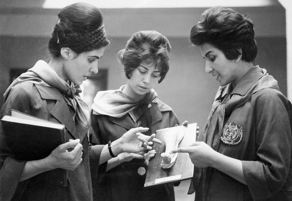Faculty of Medicine in Kabul of two Afghan medicine students listening to their professor (at right) as they examine a plaster cast showing a part of a human body, 1962.