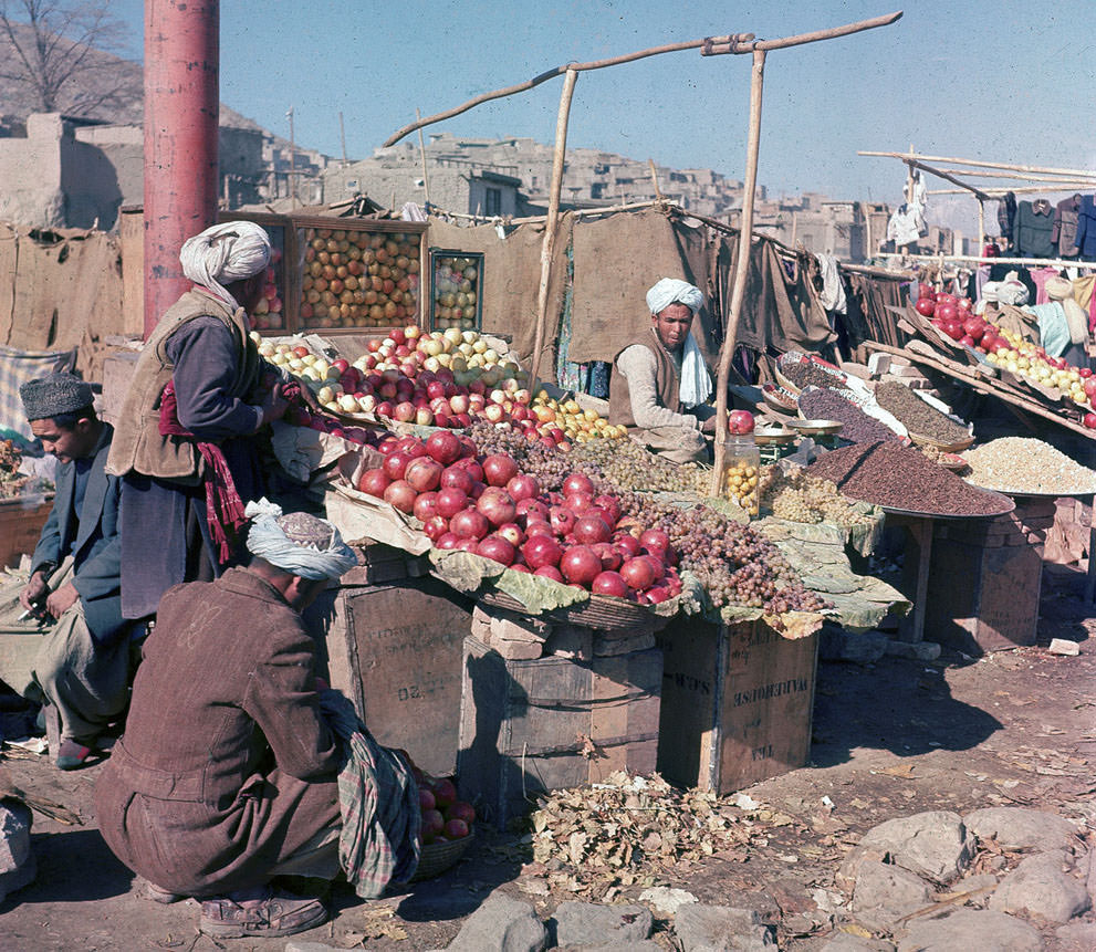Vendors sell various fuits and nuts at an outdoor market in Kabul, in November of 1961.