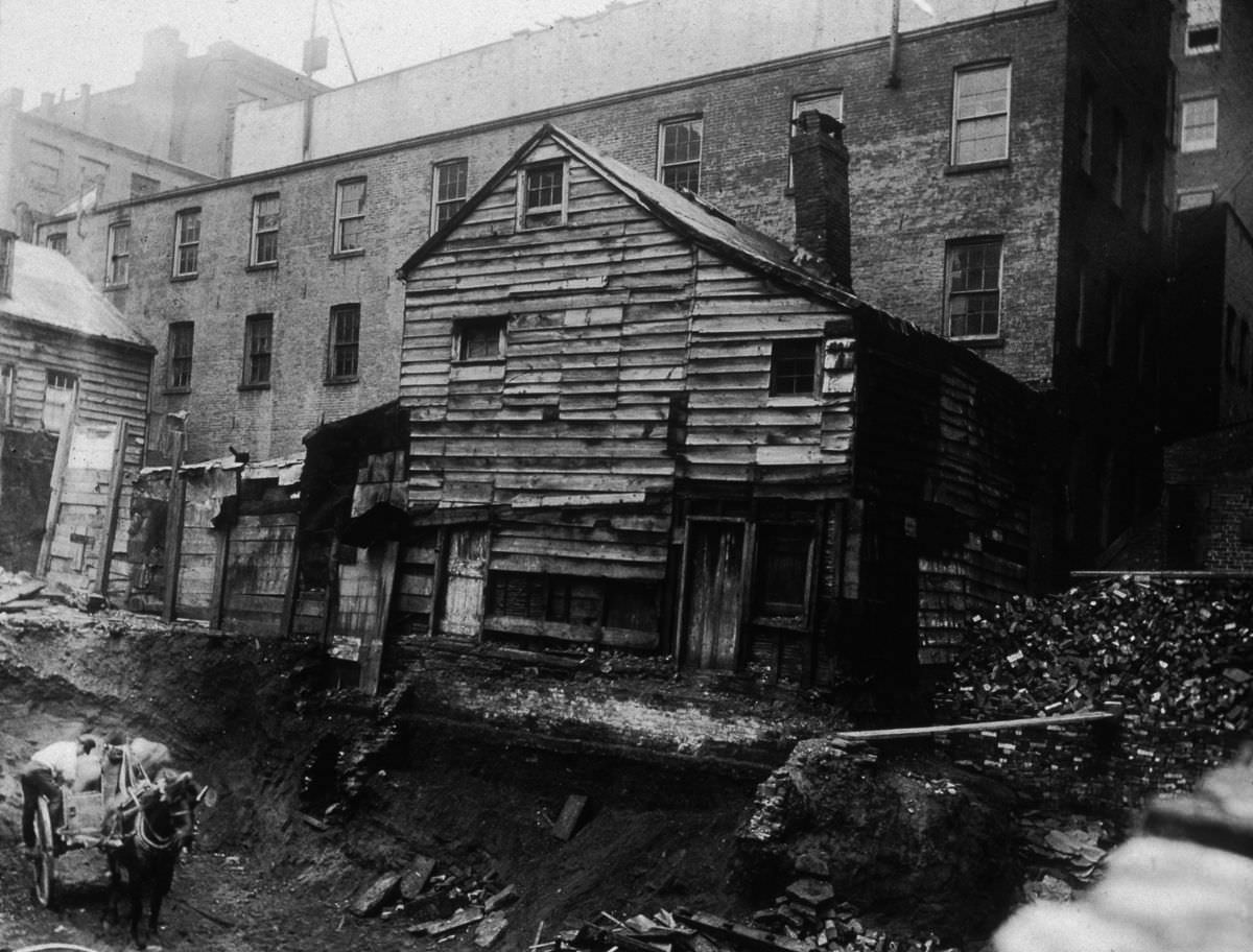 A backlot house on Bleecker Street between Mercer and Greene Streets, adjacent to an excavation site, 1890