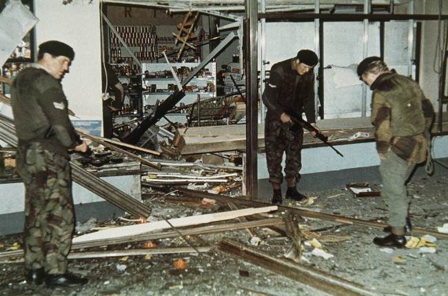 British troops sift through the ruins of a supermarket after a bomb exploded in Cavehill Road, Belfast, Northern Ireland in 1971.
