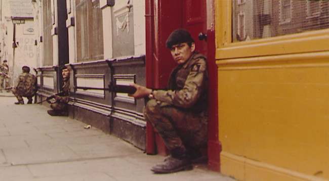 British troops take up positions in the doorways of shops near Eliza street, in the markets area of Belfast, a short distance from the city centre of Northern Irelands capital. Area was the scene of continued bitter fighting as British forces clashed with elements of the Irish Republican Army provis