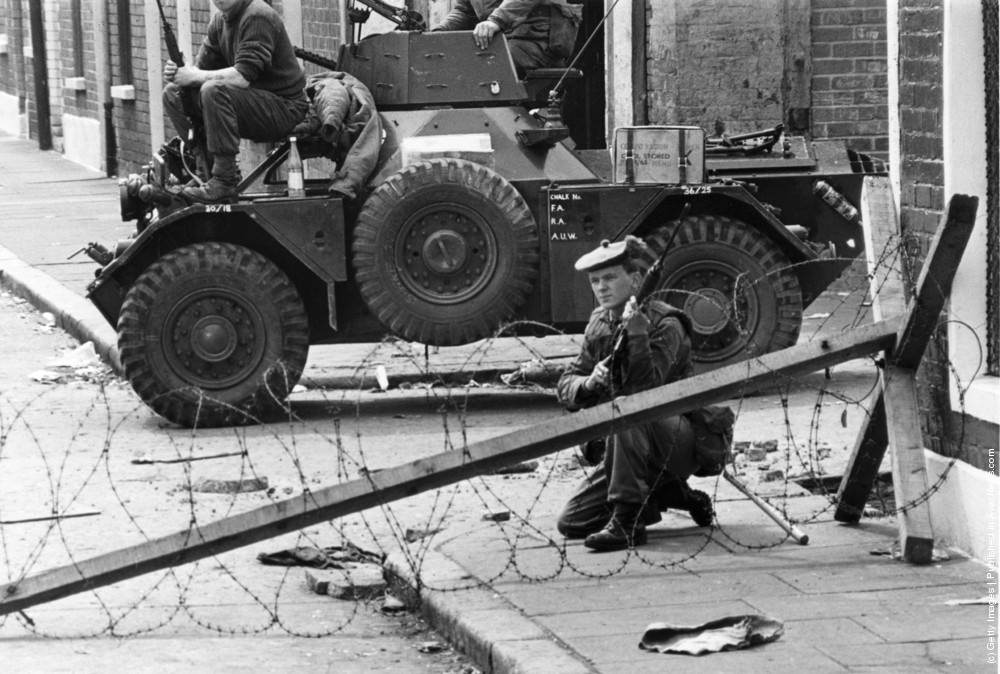 Armed British soldiers impose a curfew on the Falls Road in Belfast, July 1970.