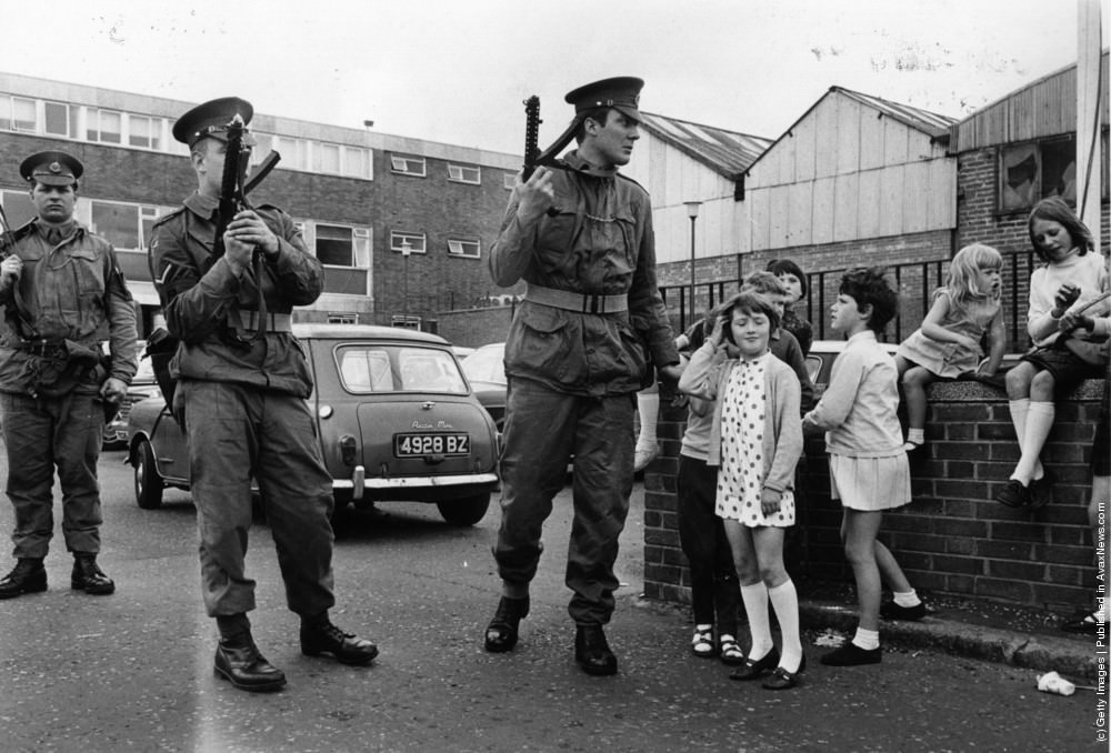 Armed British soldiers impose a curfew on the Falls Road in Belfast, July 1970.