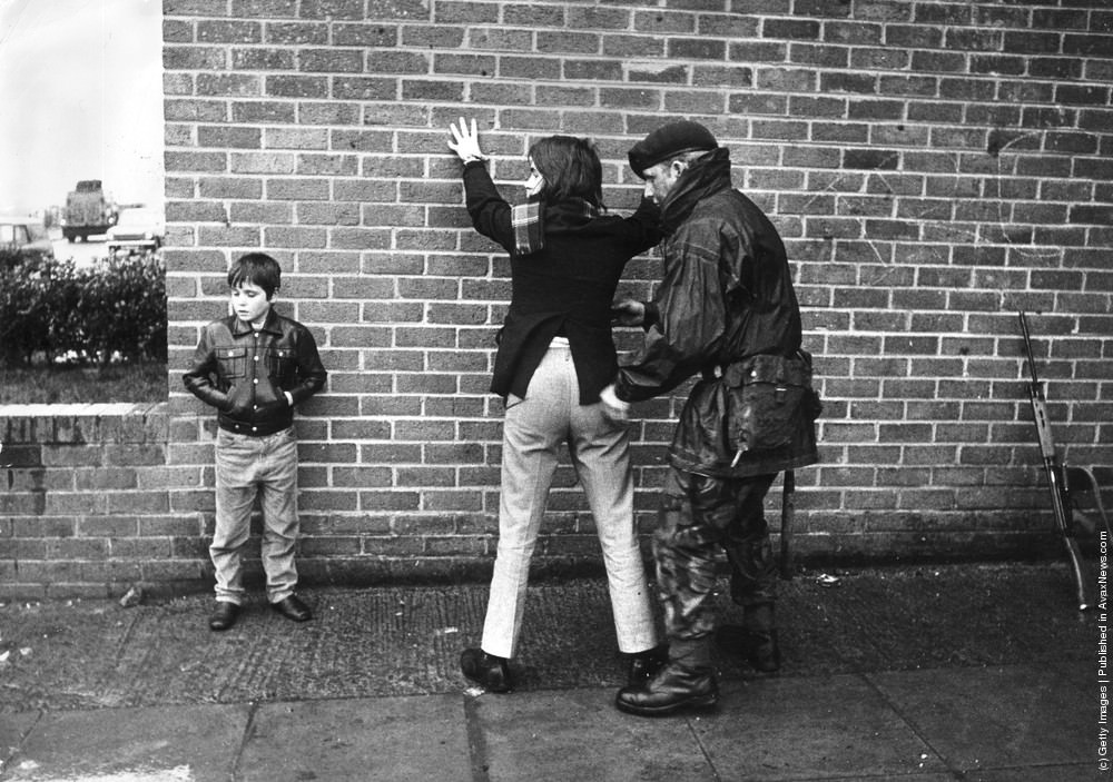 A British soldier searching a Belfast teenager, 1971.