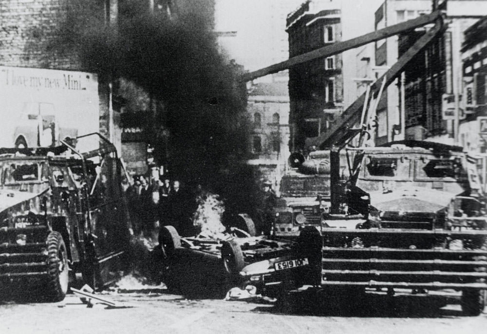 A British Army Humber Pig passes through a burning barricade, 1972.