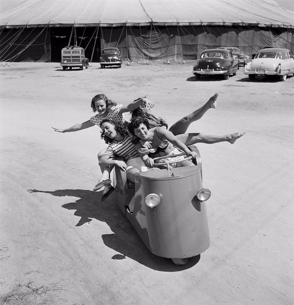 A group of circus girls taking a ride in a circus vehicle during a rehearsal for the Ringling Bros. and Barnum & Bailey Circus in Sarasota, FL in 1949.